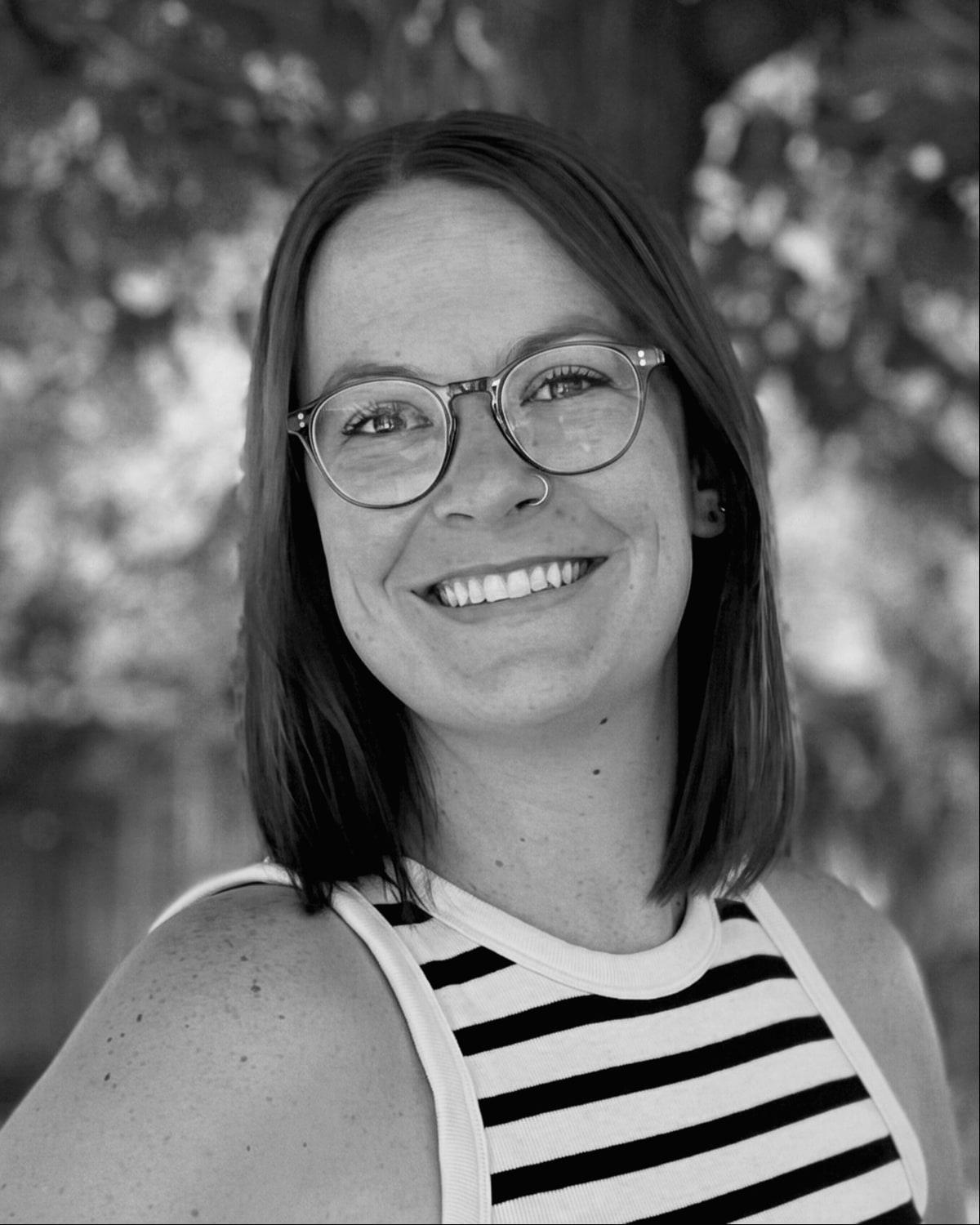 Erin Johnson of The Untamed Rose, smiling, outdoors beneath a tree